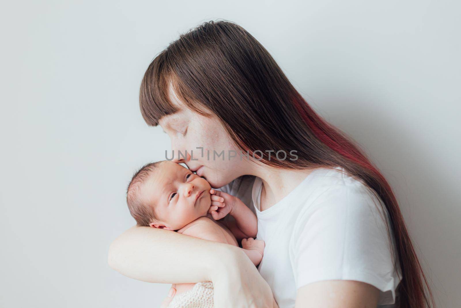 Mom holds the baby in her arms lifestyle . Mother's love for her son. A newborn baby. Mother and child relationship.