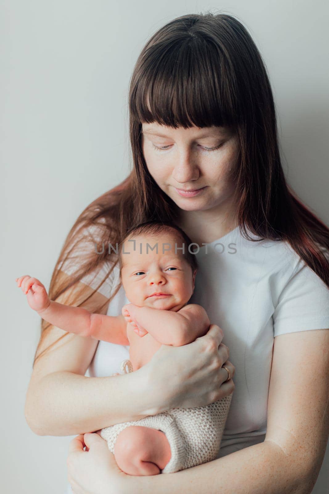 Mom holds the baby in her arms lifestyle . Mother's love for her son. A newborn baby. Mother and child relationship.
