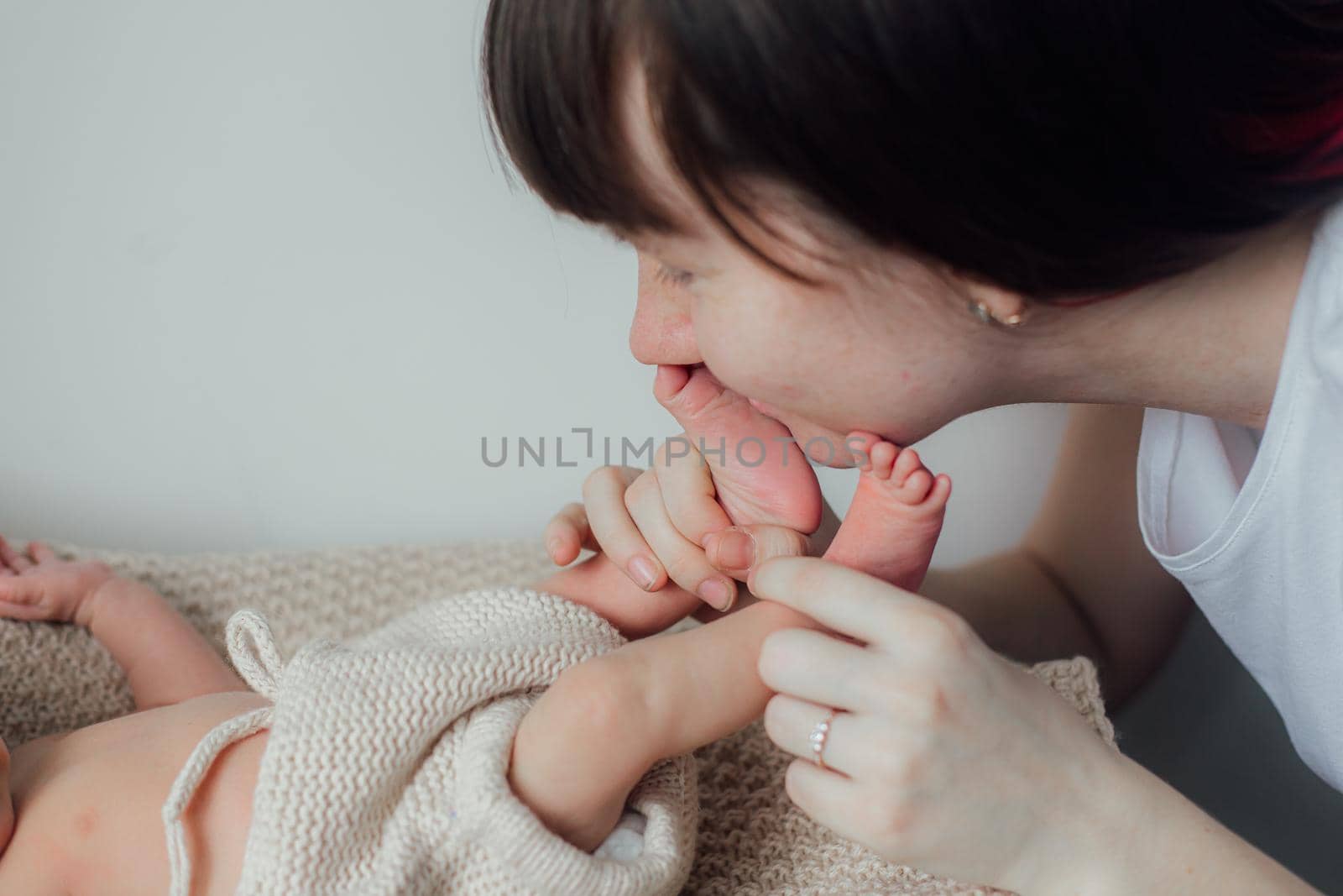 Mom holds the baby in her arms lifestyle . Mother's love for her son. A newborn baby. Mother and child relationship.