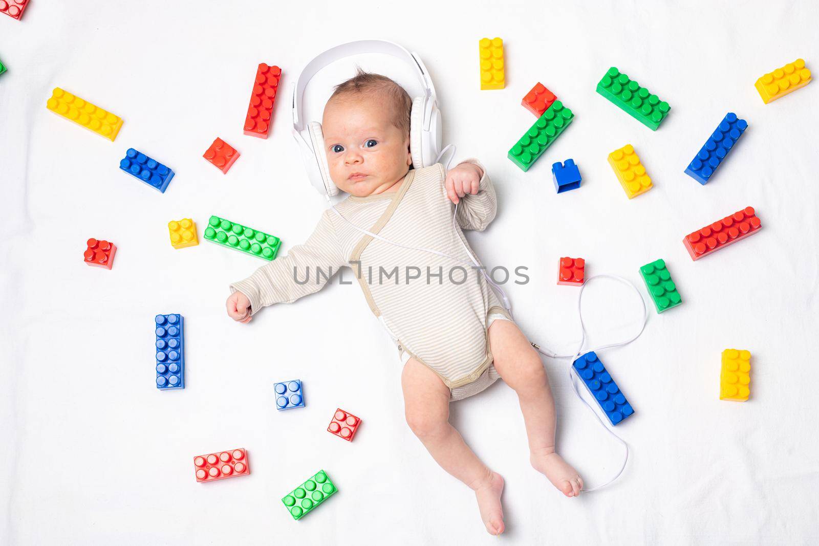 The baby is lying in toys . An article about children's toys. A selection of toys for kids. by alenka2194