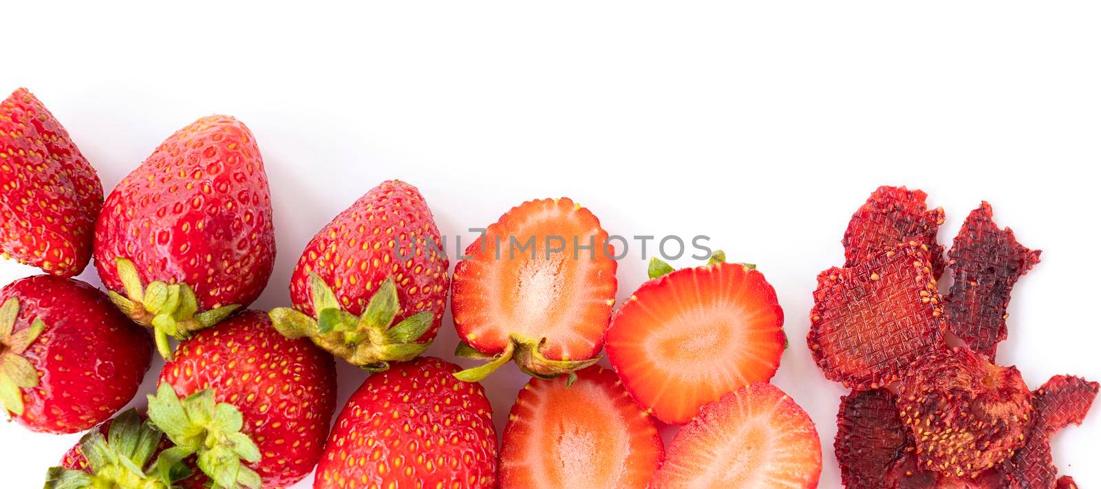 banner with healthy sweets. ripe sweet strawberries, red strawberry slices, dried strawberry pieces. fruit chips. healthy food concept. top view. by Leoschka