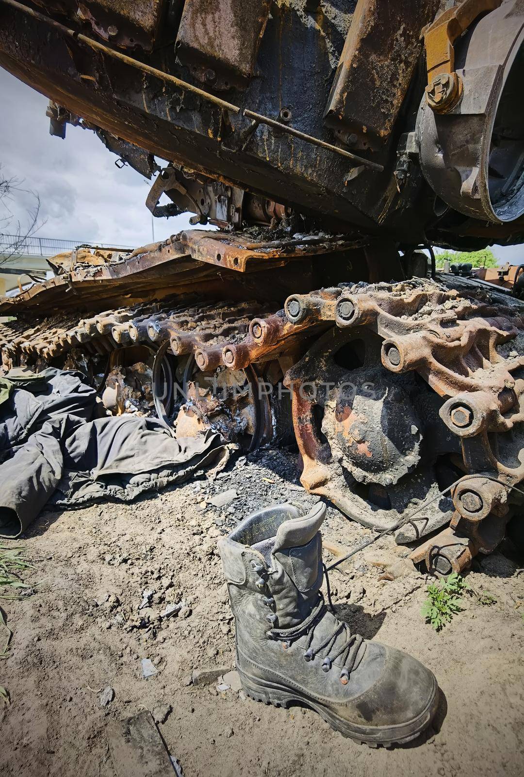 Kyiv region, Ukraine - May 15, 2022: War in Ukraine. Highway Kyiv - Zhytomyr. People take selfies against destroyed russian tank after russian atack in Febrary