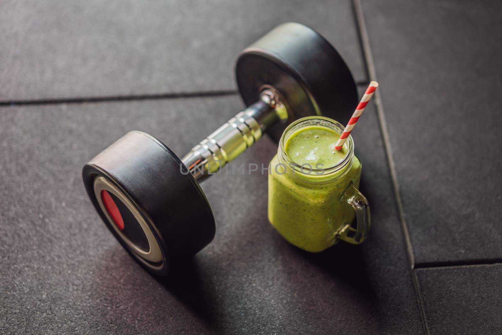 Green smoothies and dumbbells in the gym.