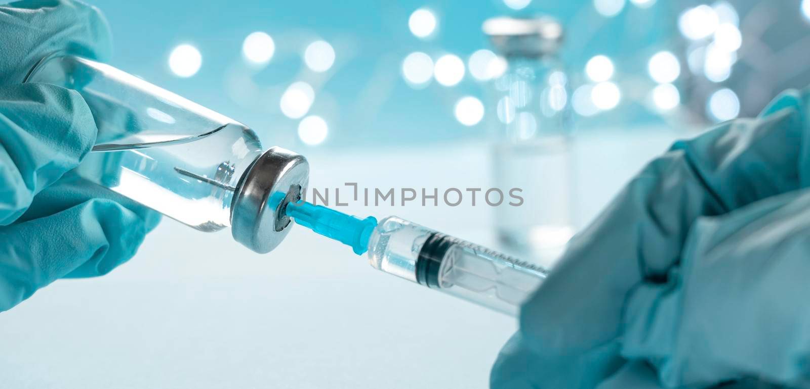 banner with doctor, nurse, scientist, researcher hand in blue gloves holding flu, measles, coronavirus vaccine disease preparing for human clinical trials vaccination shot, medicine and drug concept.