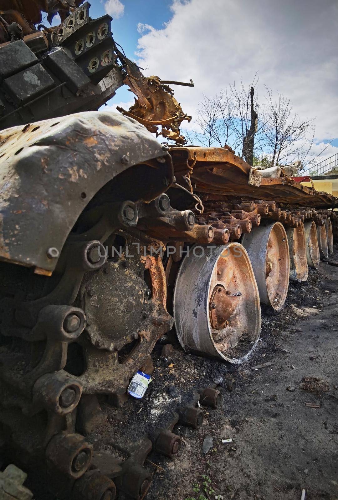 Kyiv region, Ukraine - May 15, 2022: War in Ukraine. Highway Kyiv - Zhytomyr. People take selfies against destroyed russian tank after russian atack in Febrary