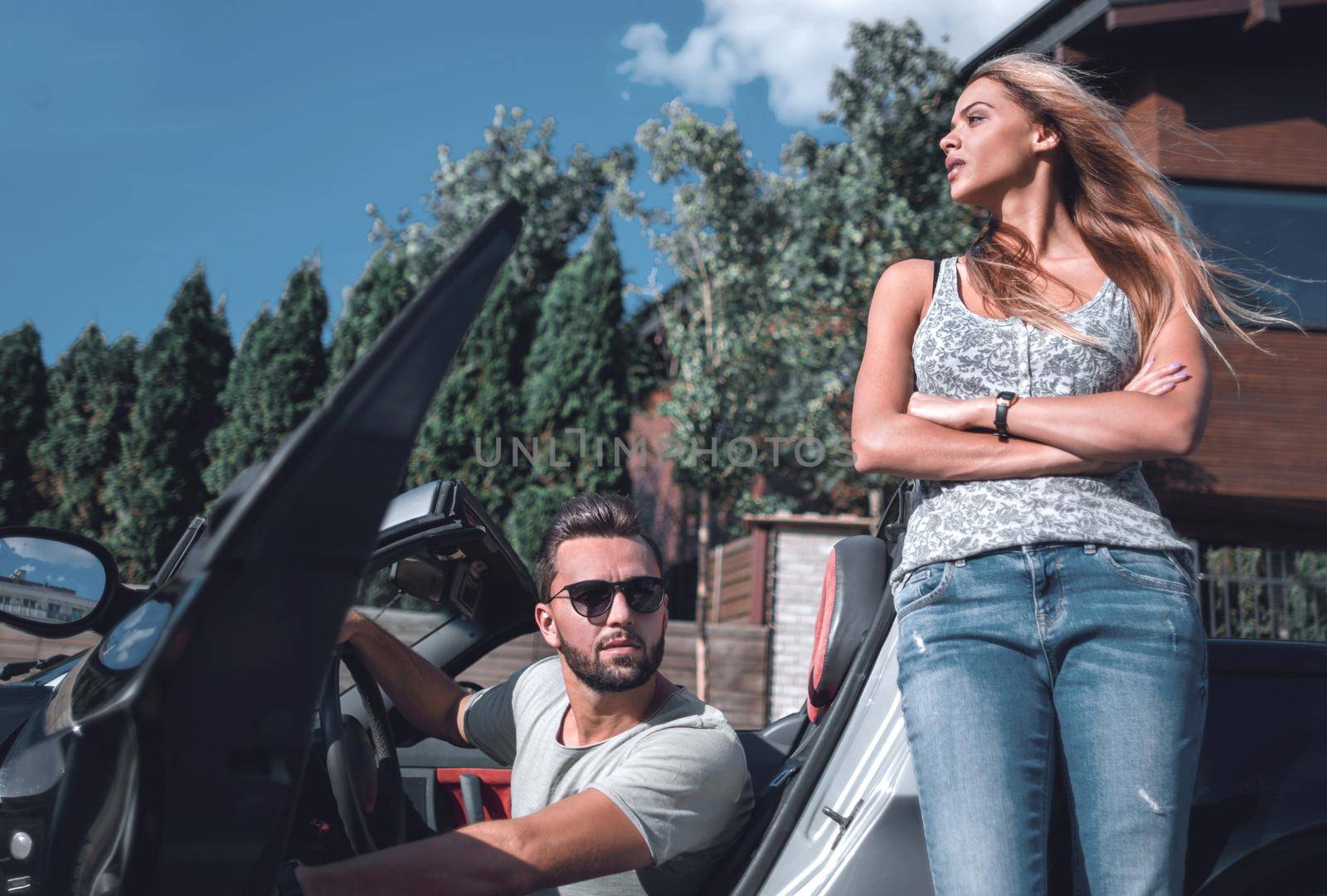 young couple standing near luxury car.the concept of a successful lifestyle