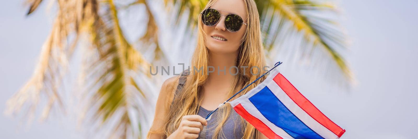 Happy woman having fun at the beach with Thailand flag. Beautiful girl enjoying travel to Asia BANNER, LONG FORMAT by galitskaya