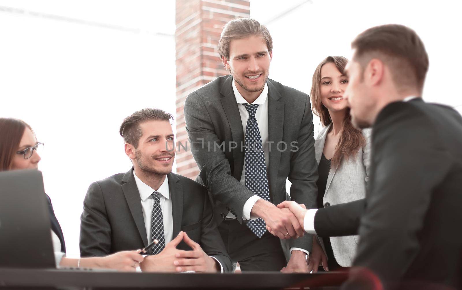 Confident businessmen sitting by table during consultation