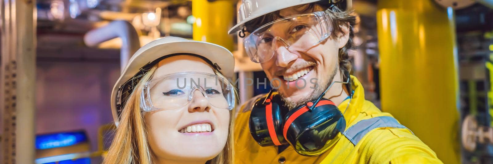 Man and woman in a yellow work uniform, glasses, and helmet in an industrial environment, oil Platform or liquefied gas plant BANNER, LONG FORMAT by galitskaya