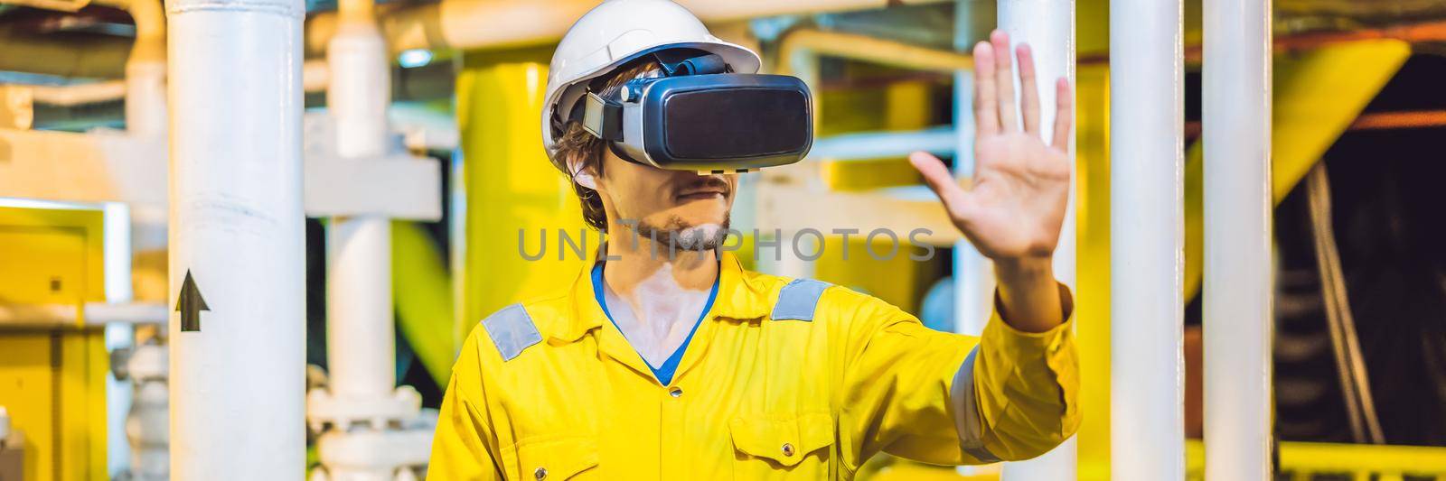 BANNER, LONG FORMAT Young woman in a yellow work uniform, glasses and helmet uses virtual reality glasses in industrial environment, oil Platform or liquefied gas plant by galitskaya