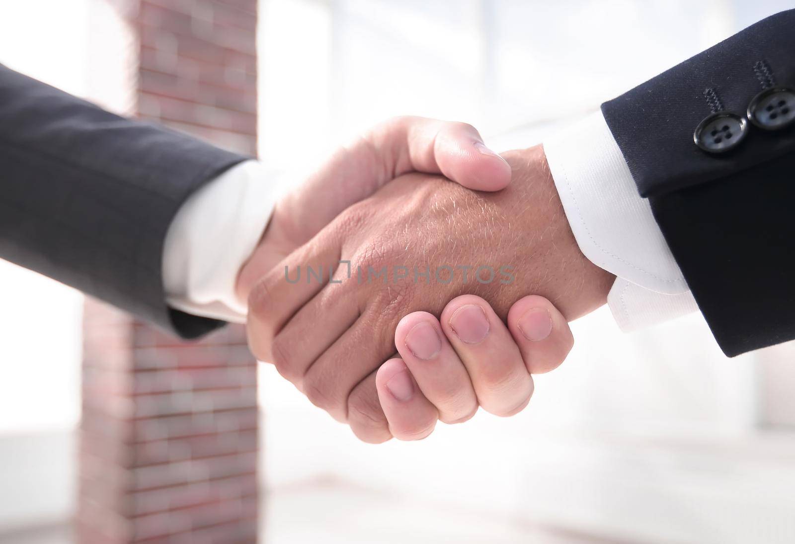 closeup.handshake of business partners by asdf