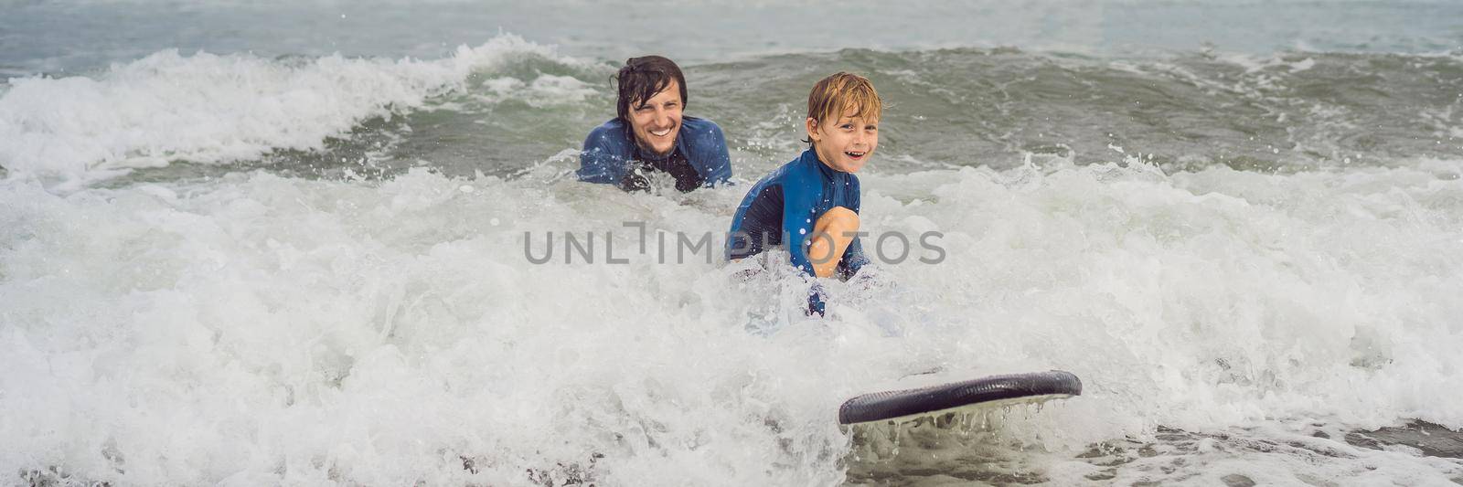 BANNER, LONG FORMAT Father or instructor teaching his 5 year old son how to surf in the sea on vacation or holiday. Travel and sports with children concept. Surfing lesson for kids.