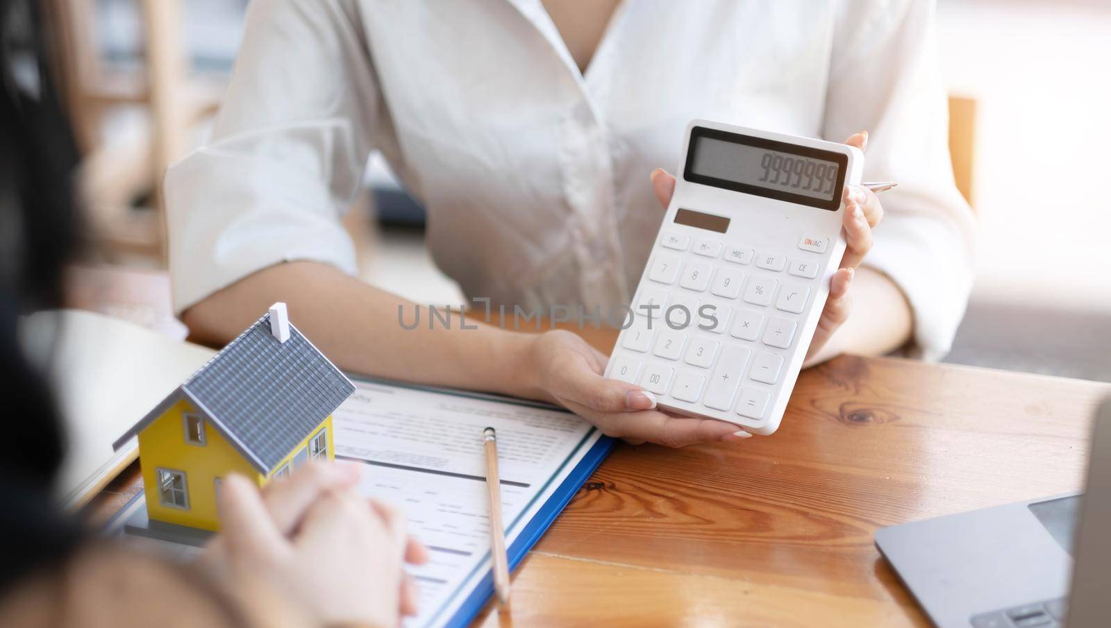 Real estate broker agent being analysis and making the decision a home estate loan to customer to signing contract documents for realty purchase, Bank employees recommend mortgage loan approval..