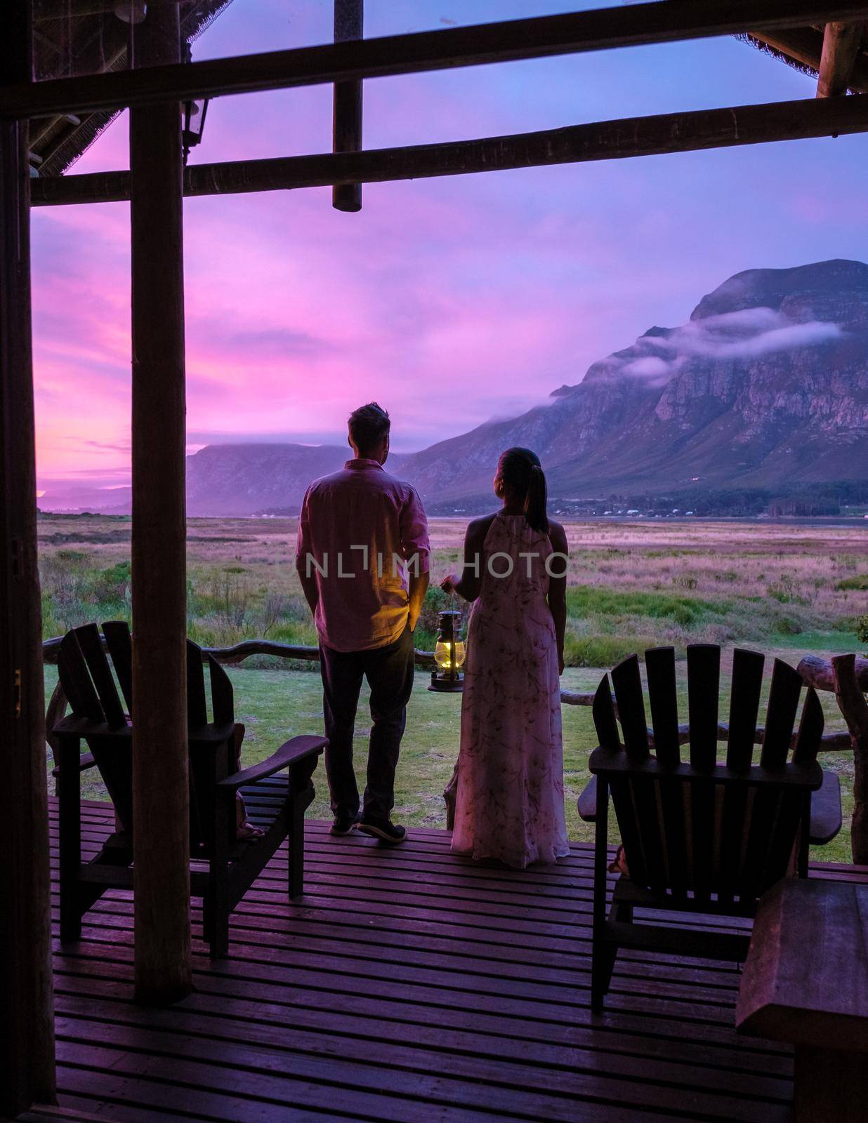 Mountains and grassland near Hermanus at the garden route Western Cape South Africa Whale coast. couple man and woman mid age in front of their lodge during vacation in South Africa