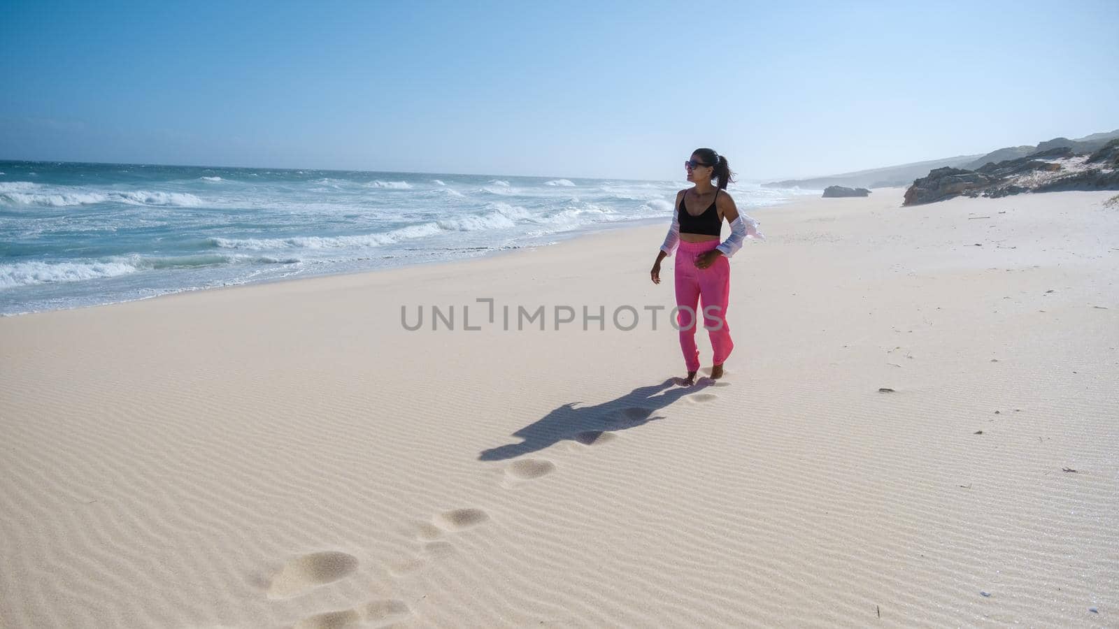 woman walking at the beach De Hoop Nature reserve South Africa Western Cape, Most beautiful beach of south africa with the white dunes at the de hoop nature reserve which is part of the garden route by fokkebok