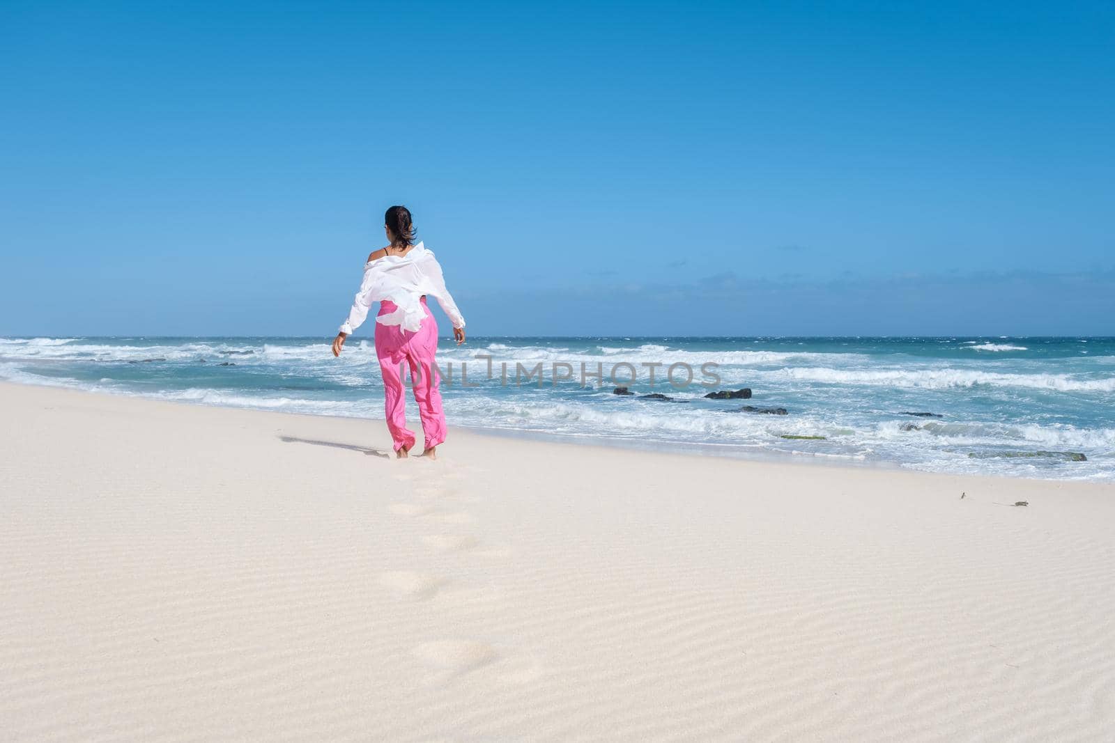 Women walking at the beach De Hoop Nature reserve South Africa Western Cape, the Most beautiful beach of south Africa with the white dunes at the de hoop nature reserve which part of the garden route