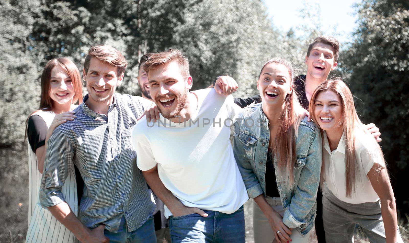 portrait of a group of friends on the background of the Park by asdf