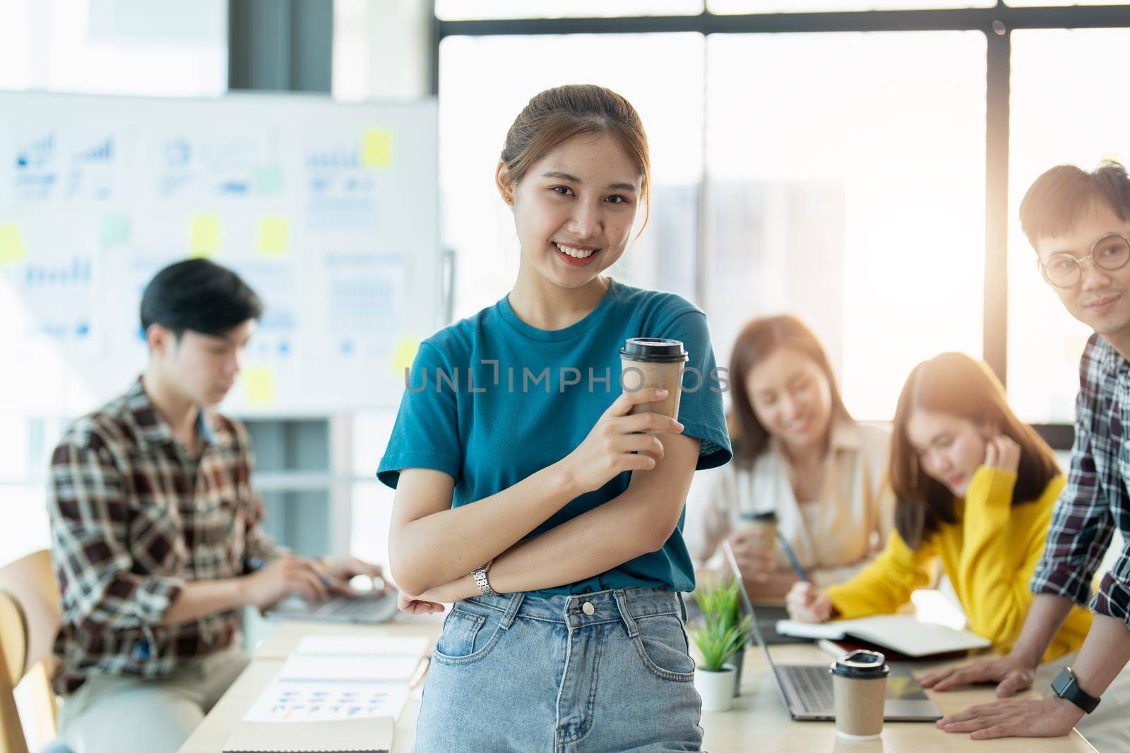 Group of asian young creative happy enjoy laugh smile and great success emotion teamwork people business startup entrepreneur casual brainstorm business meeting office background by nateemee