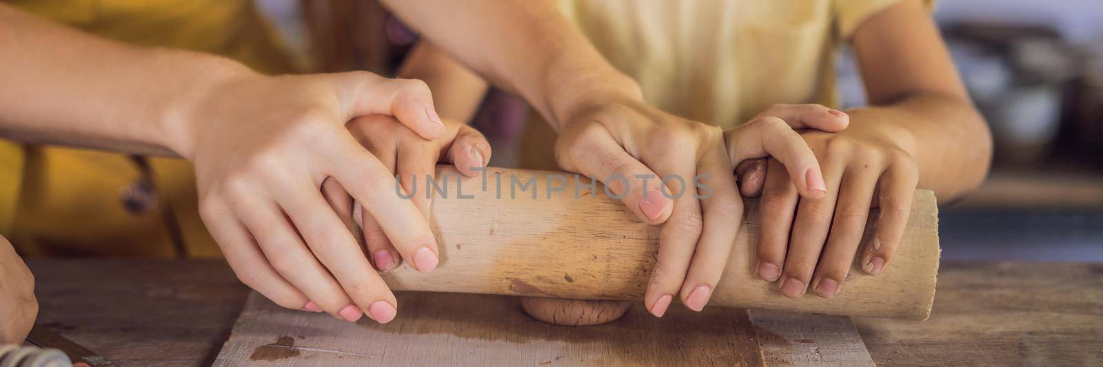 mother and son doing ceramic pot in pottery workshop. BANNER, LONG FORMAT