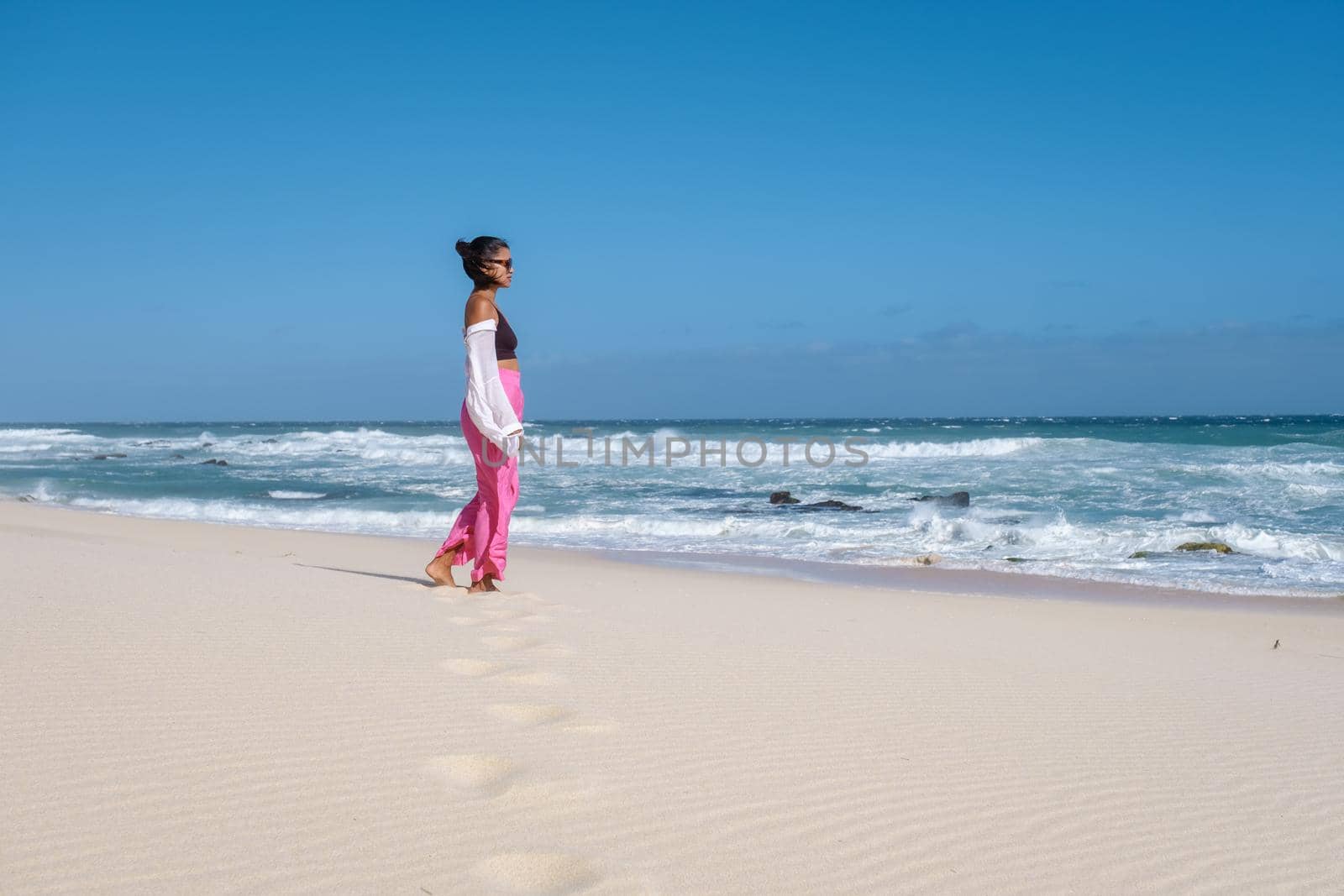 woman walking at the beach De Hoop Nature reserve South Africa Western Cape, Most beautiful beach of south africa with the white dunes at the de hoop nature reserve which is part of the garden route by fokkebok