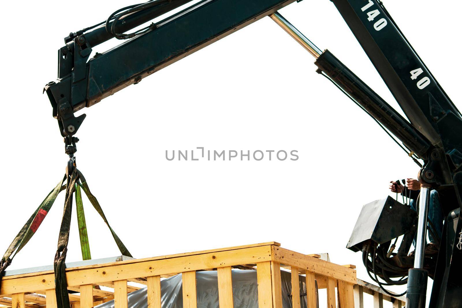 Worker working with mobile crane isolated on white background. Crane delivery machine in wooden box from truck to factory warehouse. Freight transport. Heavy goods. Warehouse and shipping business.