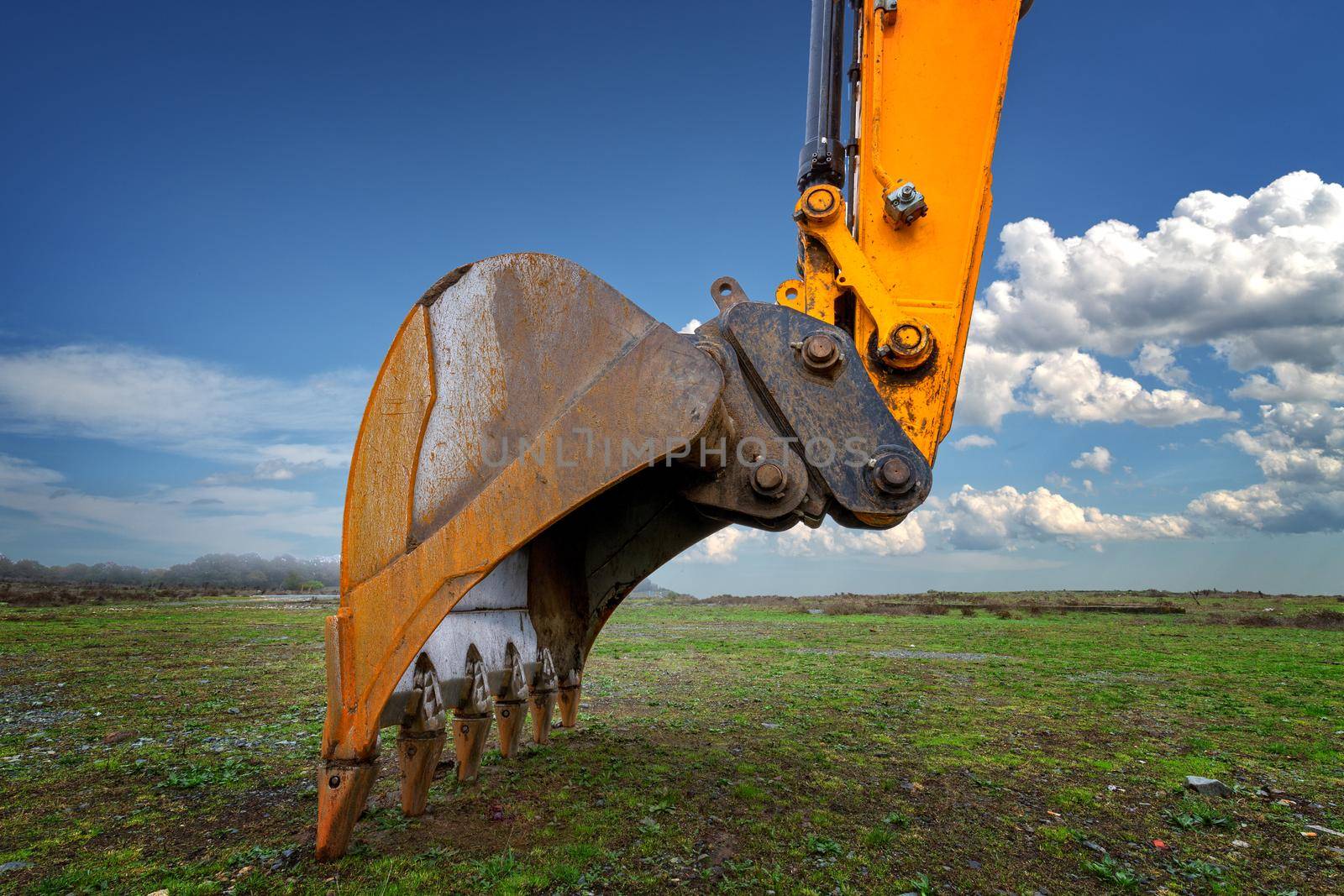 Industrial background. Digger bucket close-up. Construction excavator bucket.