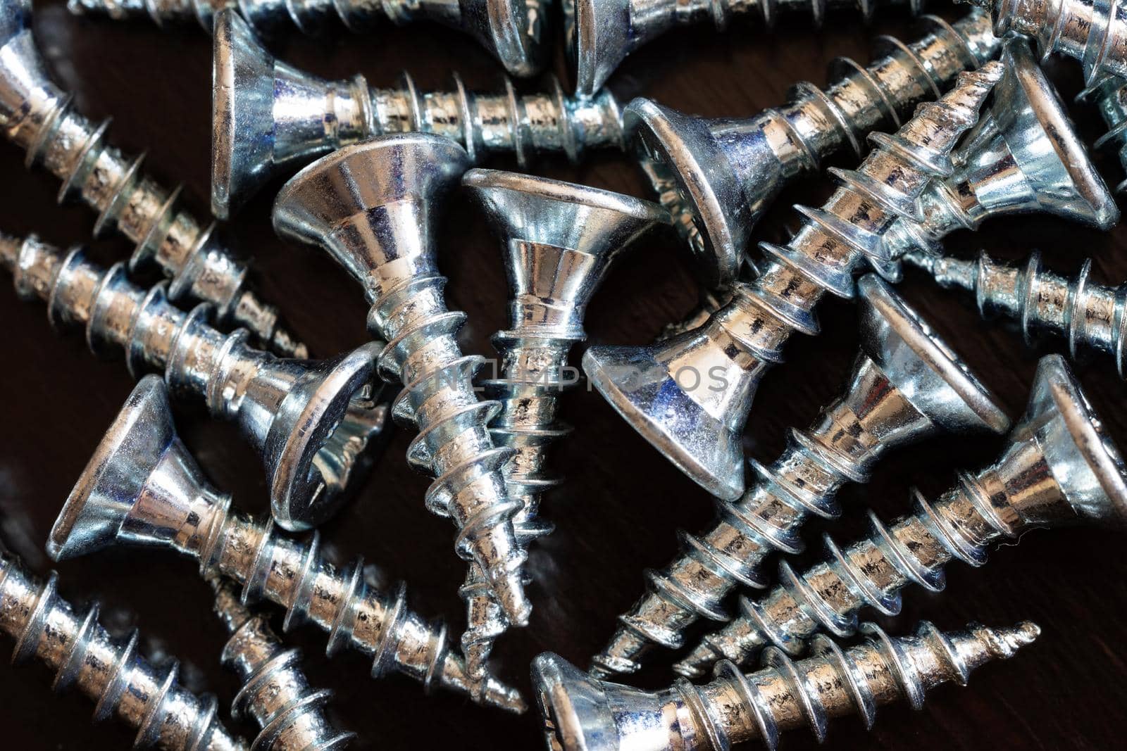 Top view of screws on a black background.