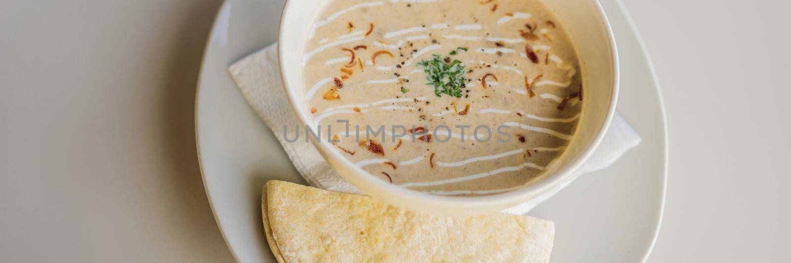 Puree soup with bread on white table. BANNER, LONG FORMAT
