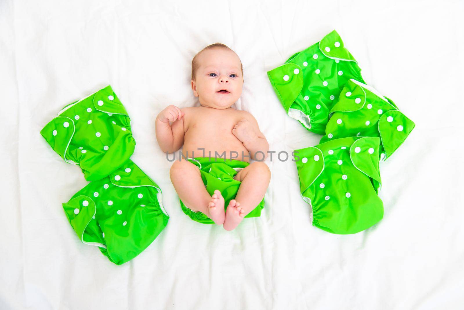 Reusable diaper on the baby copy space . An article about reusable diapers. Saving on diapers. Concern for the environment. Eco-products. Breathable diapers with buttons. High quality photo