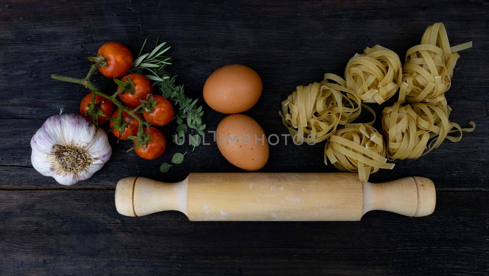top view cooking ingredients with noodles, tomatoes , eggs and spices