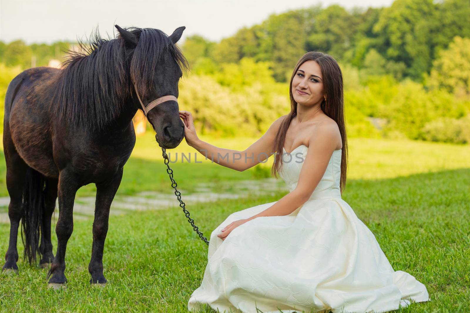 girl next to a pony on the lawn