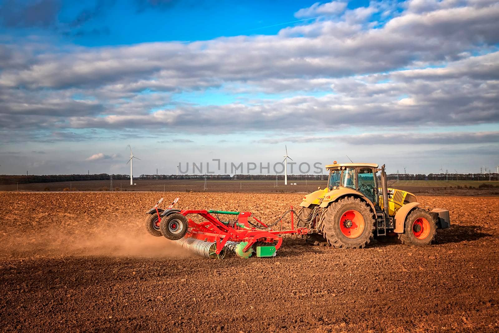 The tractor prepares the ground for sowing and cultivation. Agriculture and agronomy concept.