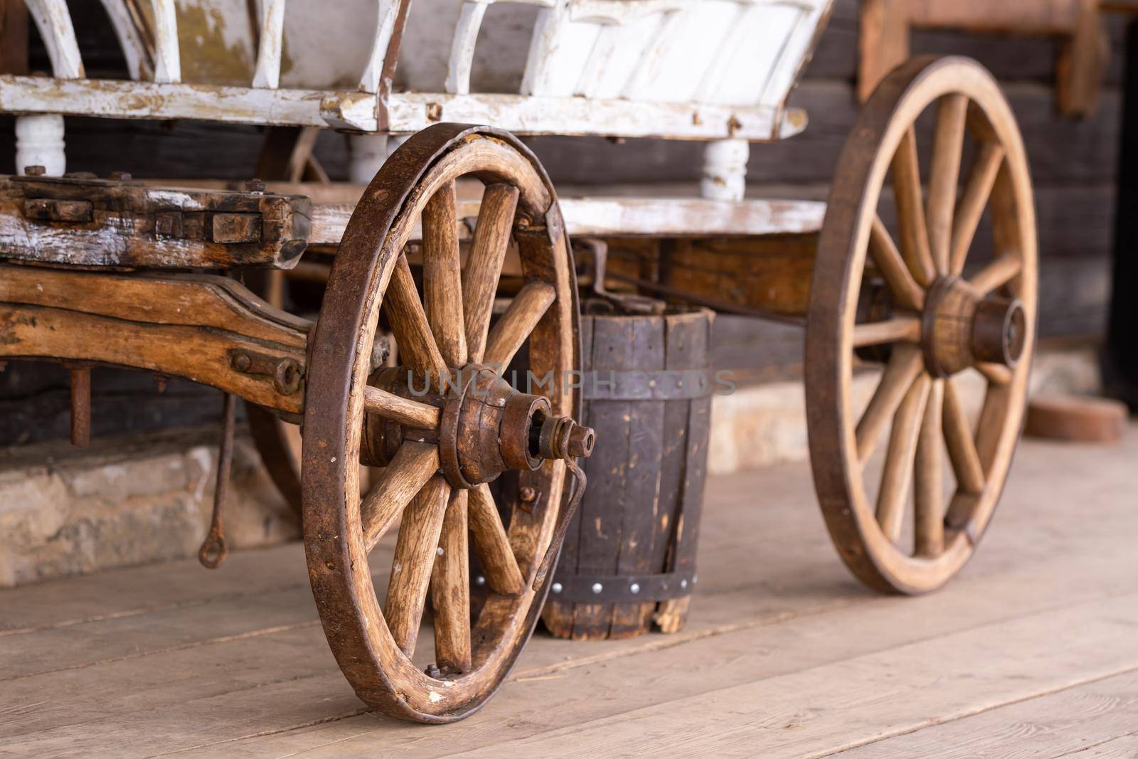 old wooden wheels are on the carriage at the ranch by Lobachad