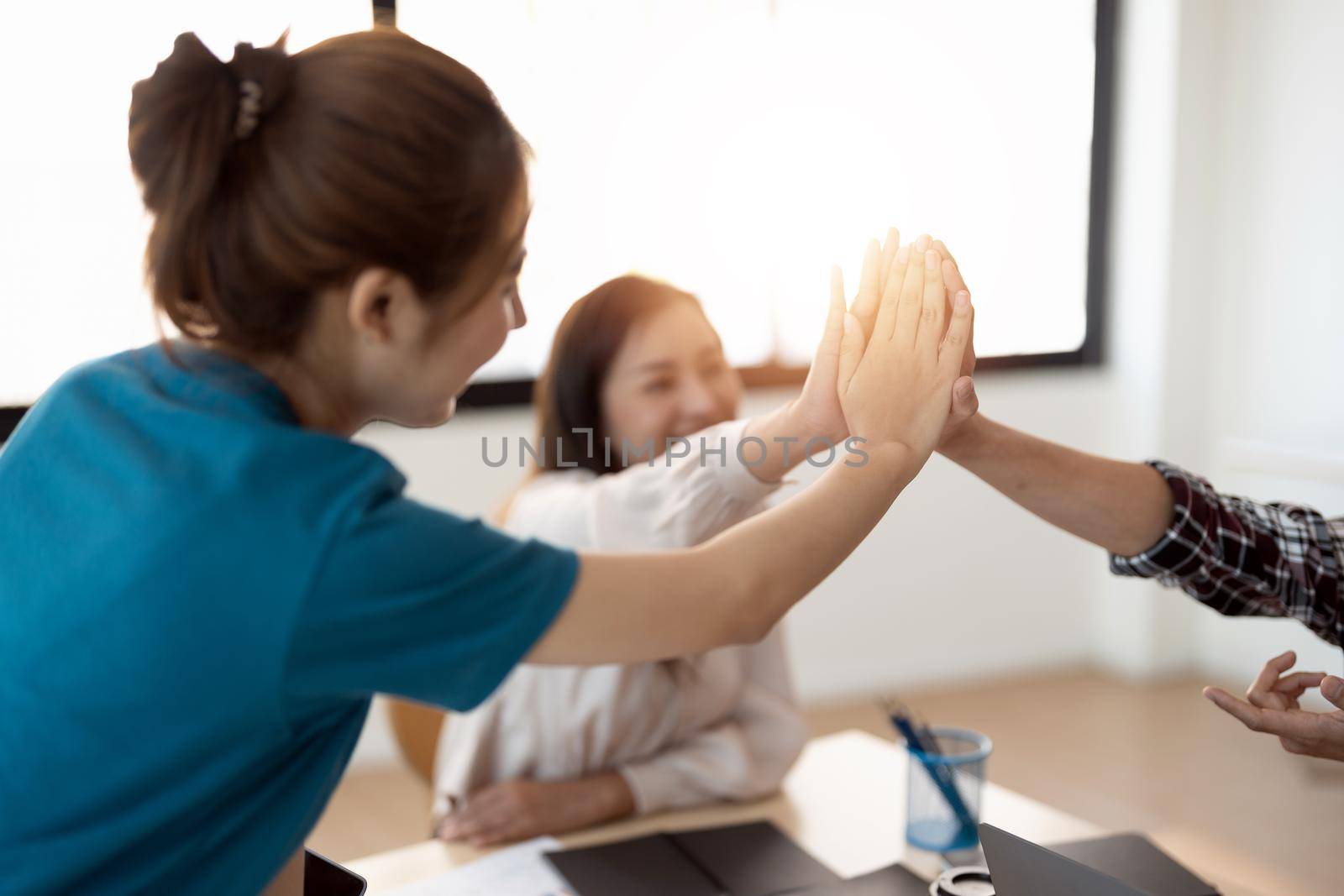 Multiracial young creative people in modern office. Group of young business people are working together with laptop, tablet, notebook. Successful hipster team in coworking. Freelancers.