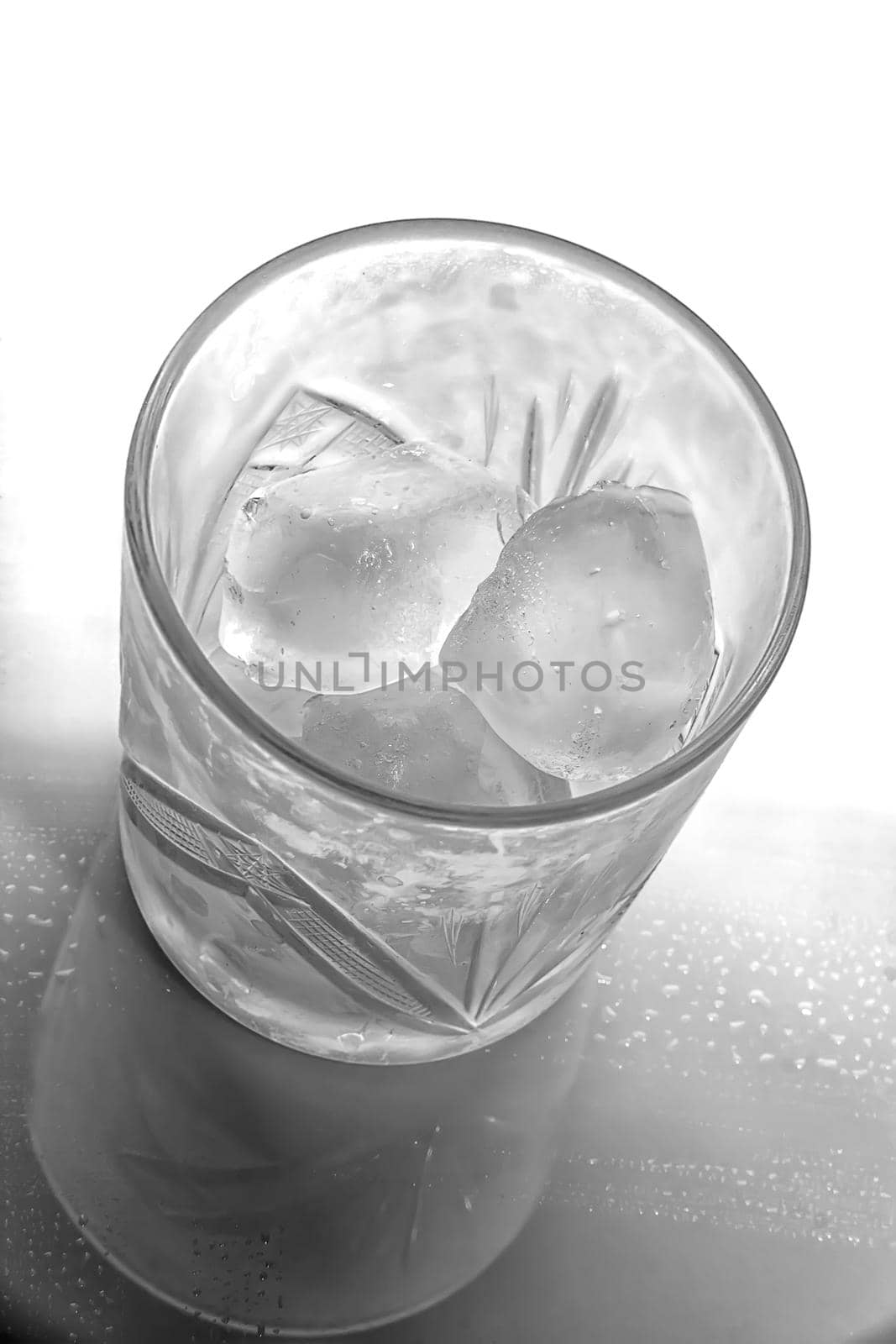 Black and white view of glass with ice cubes. Top view by EdVal