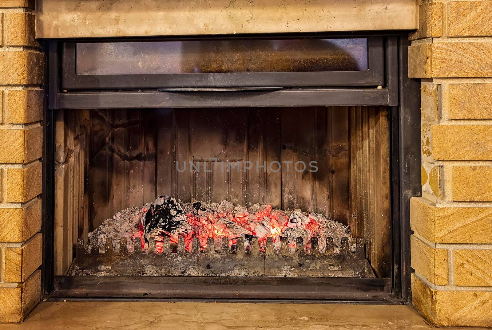 Close view of the fireplace with glowing charcoals