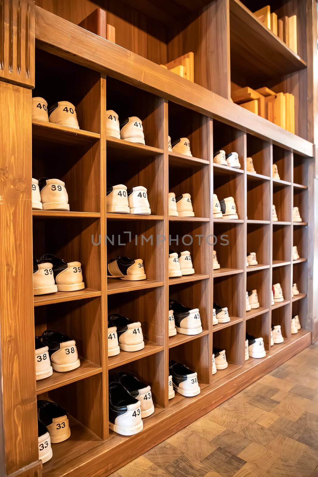 rack with shoes for bowling in different sizes. Vertical view