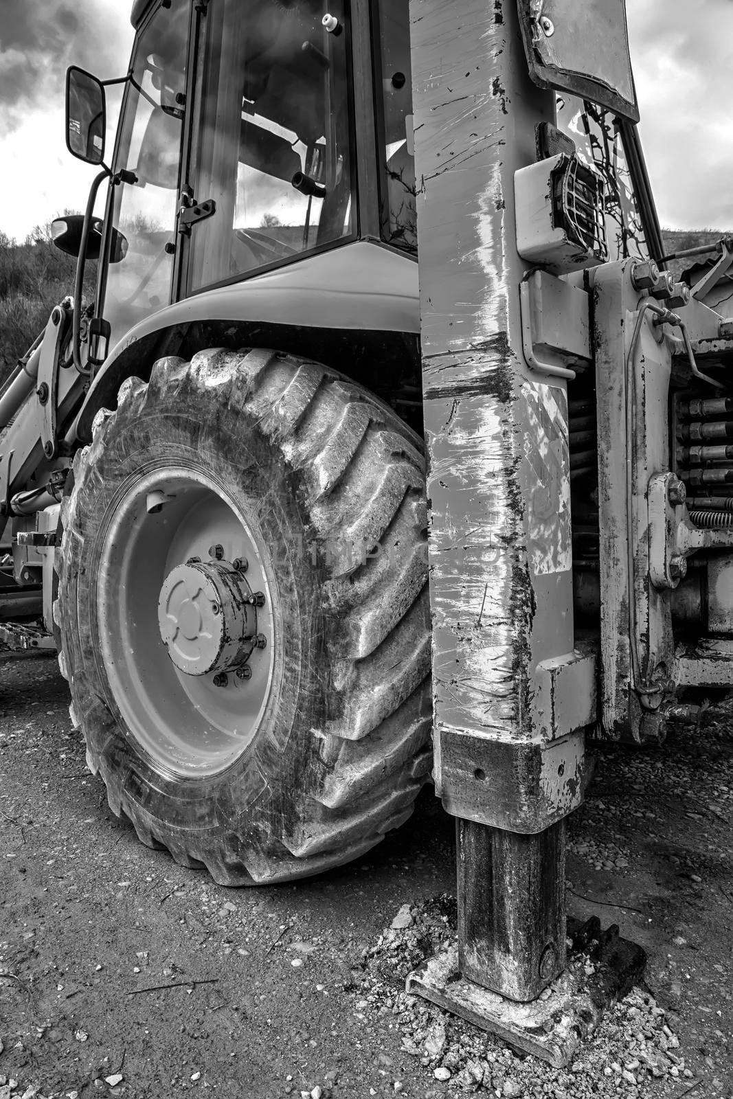 Part of excavator machines in black and white. Vertical view