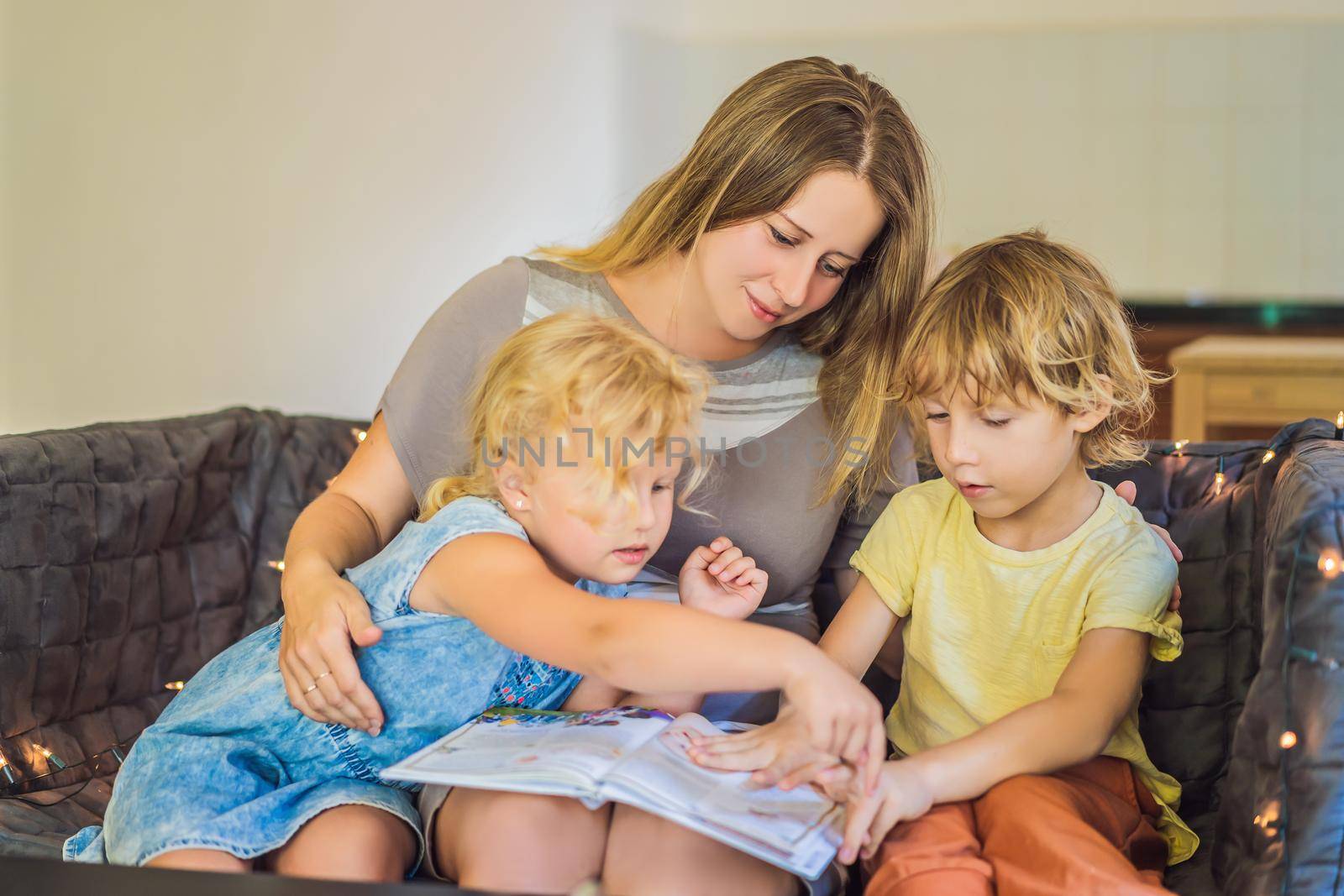 Teacher, tutor for home schooling Boy and girl at the table. Or mother, daughter and son. Homeschooling by galitskaya