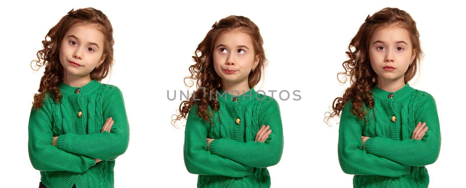 Portrait of a beautiful little girl in a green knitted sweater posing isolated on white background. by nazarovsergey