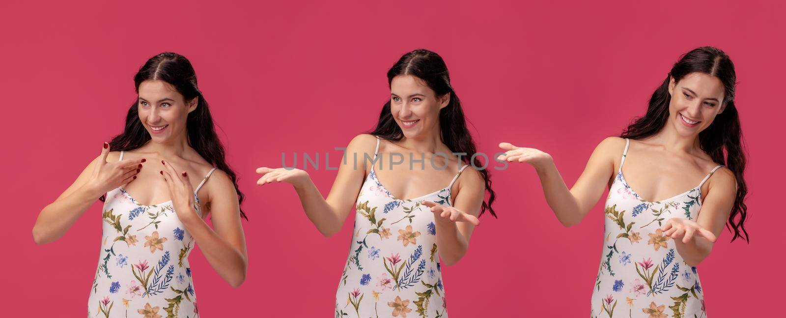 Beautiful woman in a white dress with floral print posing against a pink studio background. by nazarovsergey