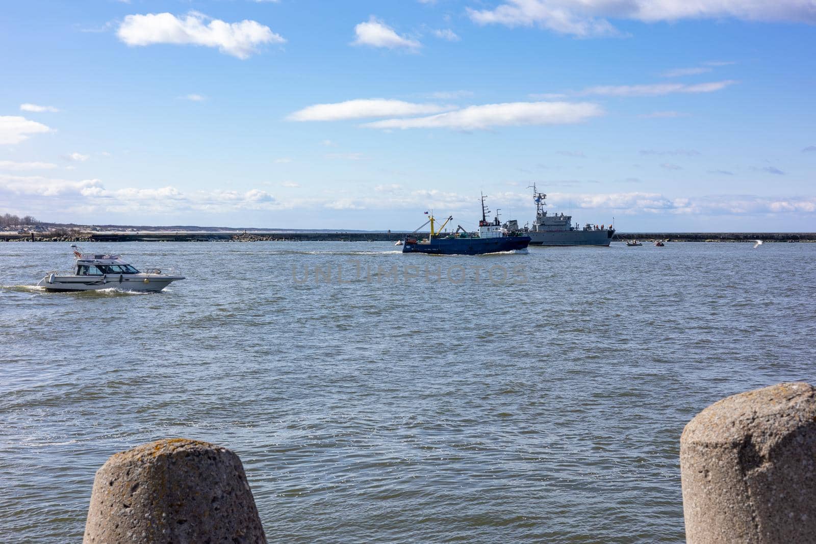 A warship and boats sail through the sea bay in Baltiysk, Kaliningrad region, Russia, near the Baltic sea.