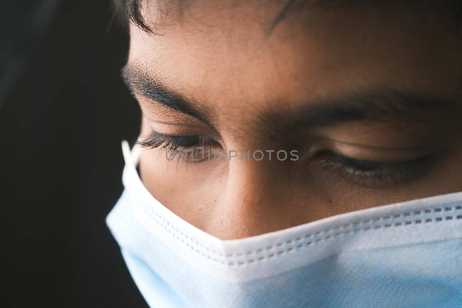 Close up of man with protective face mask looking at camera.