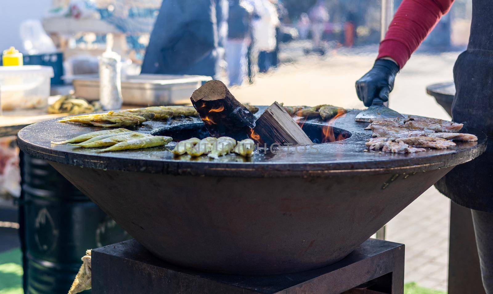 Smelt fish is fried on a large grill during the fish festival in Svetlogorsk Raushen, Kalinigrad region, Russia, near the Baltic sea. High quality photo.