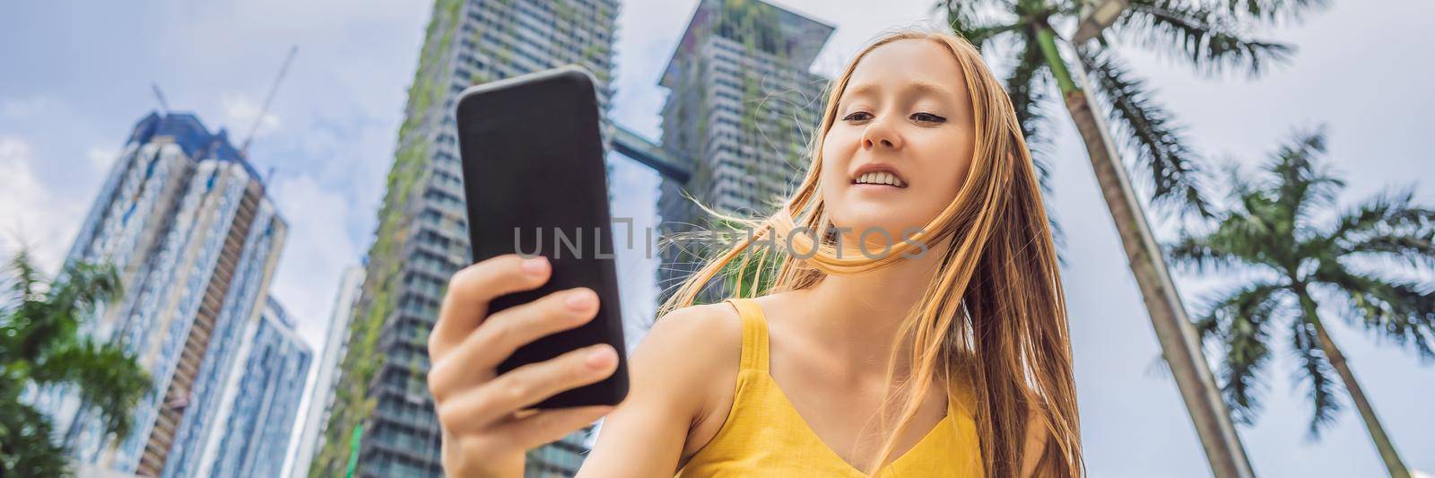 Woman Tourist using navigation app on the mobile phone. Navigation map on a smartphone in a big city. BANNER, LONG FORMAT