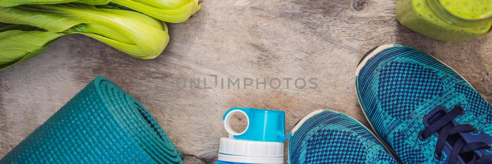 BANNER, LONG FORMAT Everything for sports turquoise, blue shades on a wooden background and spinach smoothies. Yoga mat, sport shoes sportswear and bottle of water. Concept healthy lifestyle, sport and diet. Sport equipment. Copy space by galitskaya