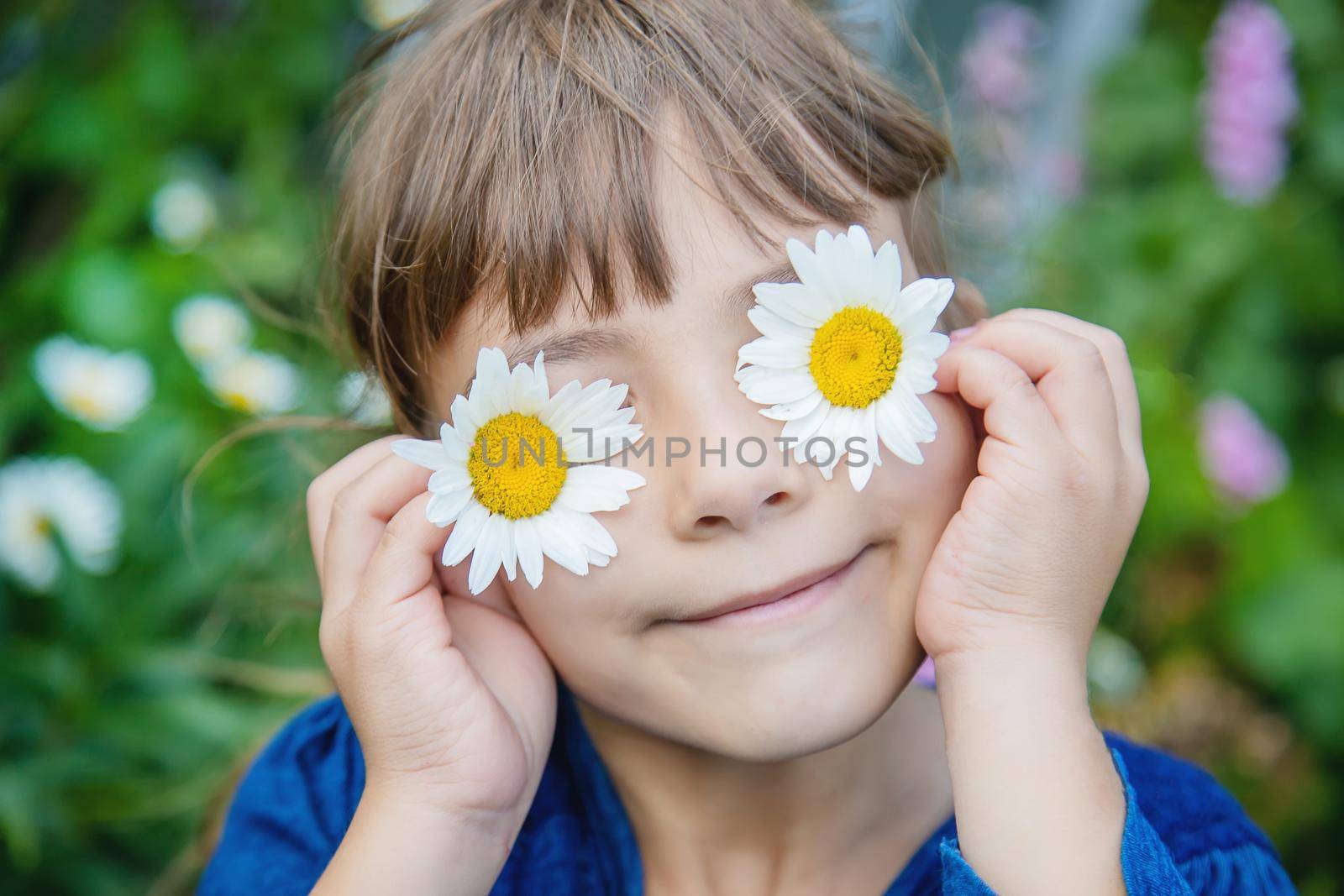 Girl with chamomile. Selective focus. nature flowers.