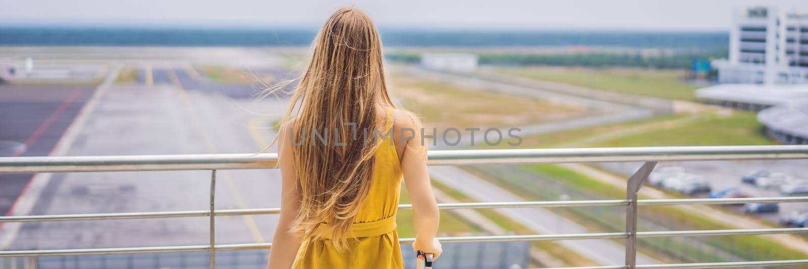 Start of her journey. Beautiful young woman ltraveler in a yellow dress and a yellow suitcase is waiting for her flight. BANNER, LONG FORMAT