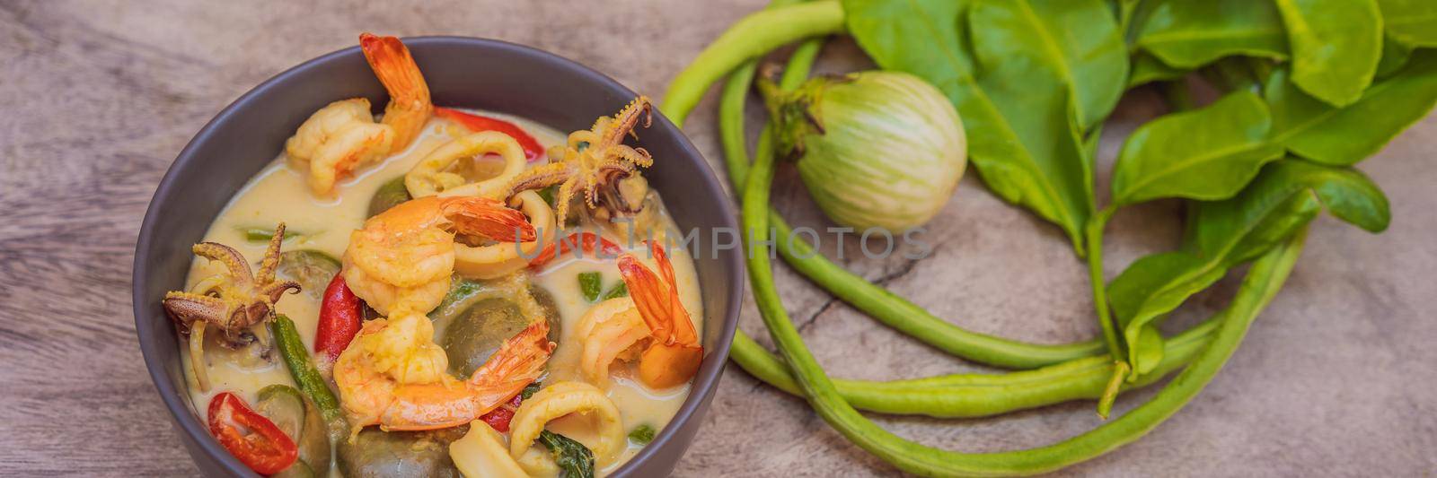 Thai food chicken green curry on dark wooden background. top view. BANNER, LONG FORMAT