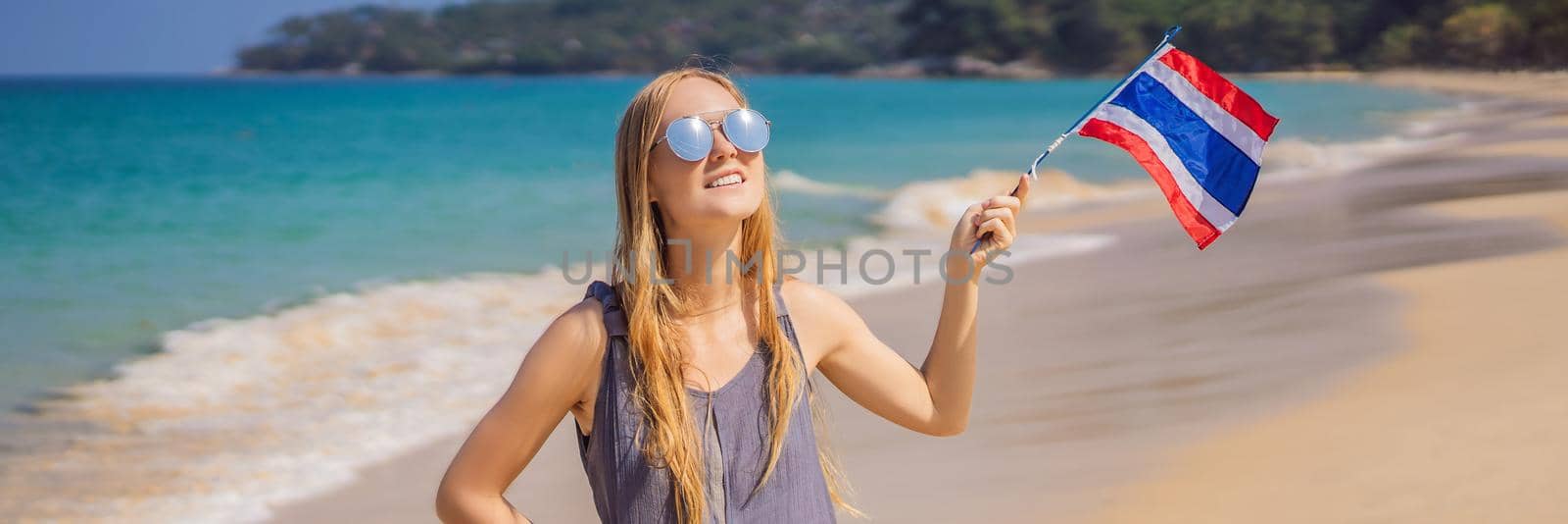 Happy woman having fun at the beach with Thailand flag. Beautiful girl enjoying travel to Asia. BANNER, LONG FORMAT